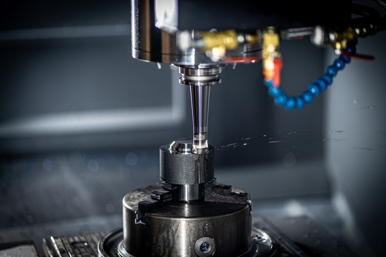 CNC lathe cutting a metal workpiece with precision tooling